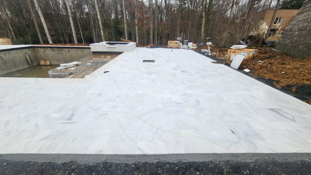 Noda Stone's Bianco Marble Coping in Pristine Pool Project