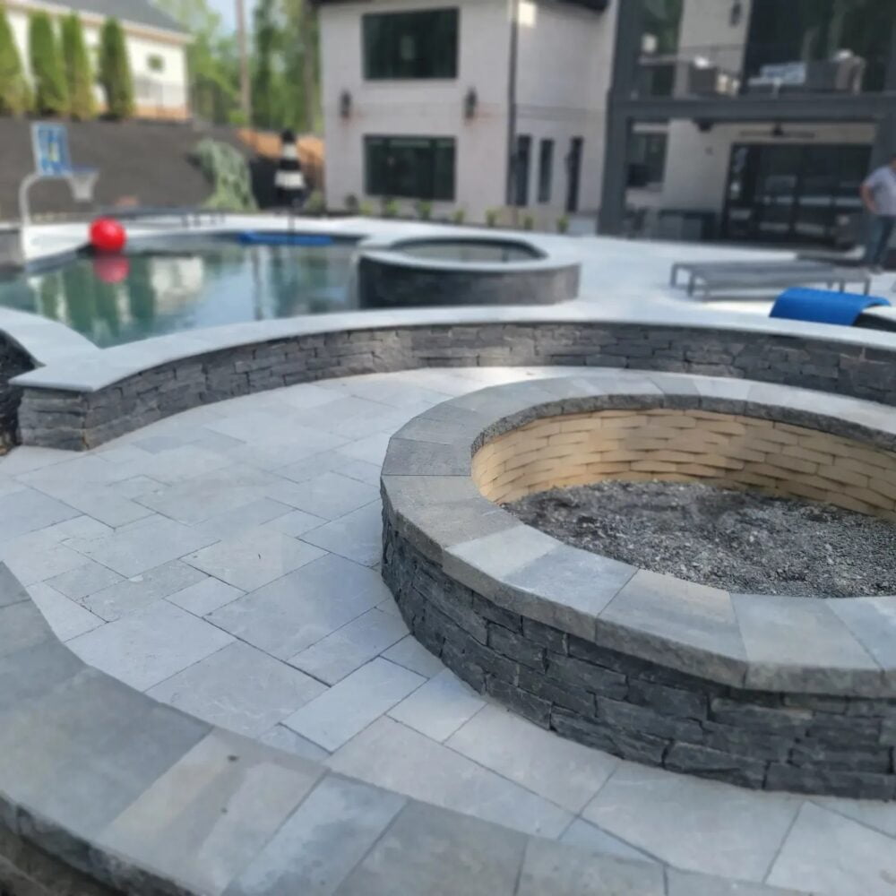 Outdoor pool area adorned with Savannah Gray coping from Noda Stone Inc