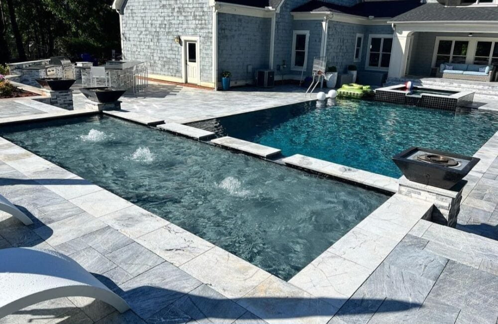 Outdoor setting showcasing Silvermoz Leather Finished Pavers by Noda Stone Inc